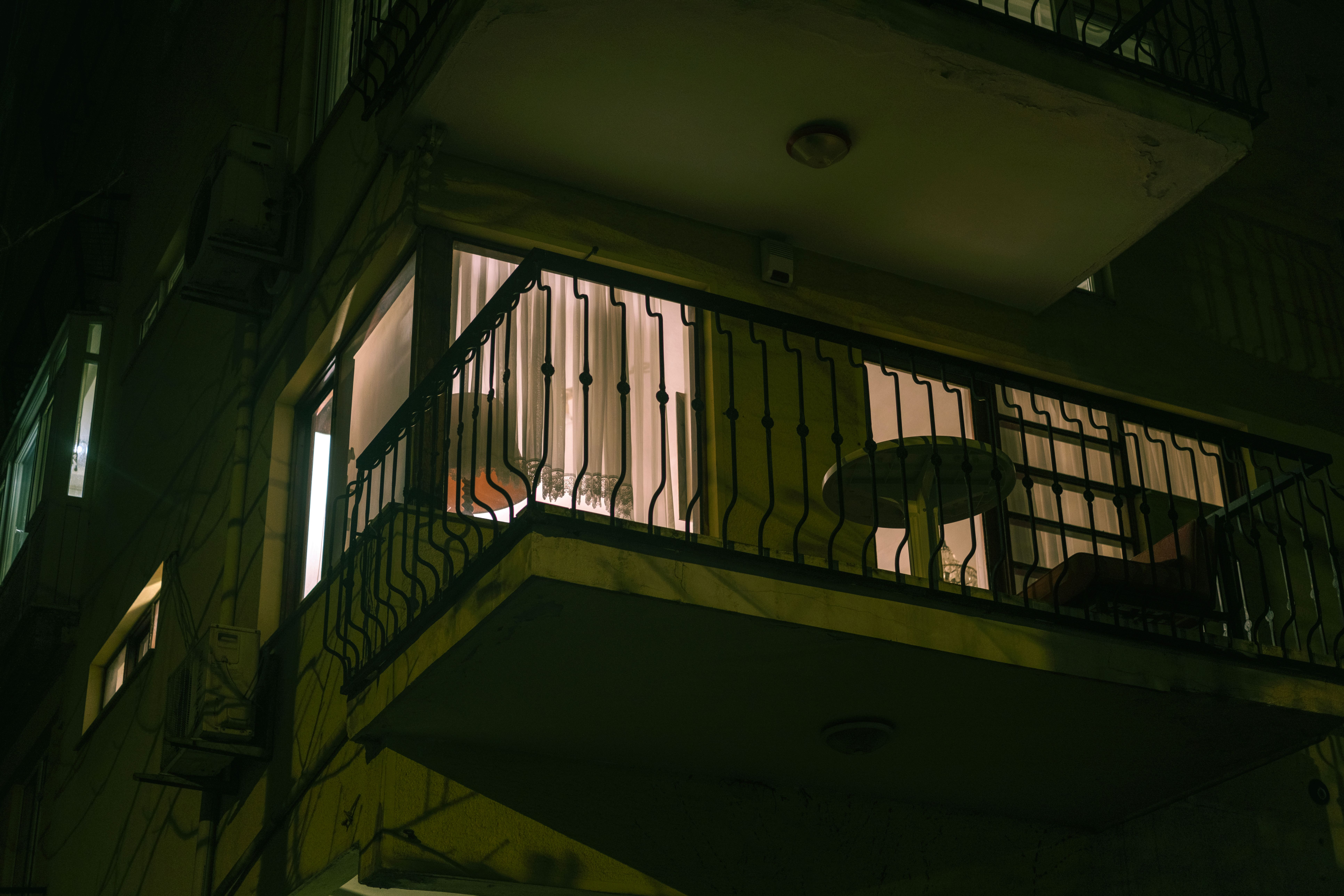 A%20quiet,%20dimly%20lit%20apartment%20patio A quiet, dimly lit apartment patio